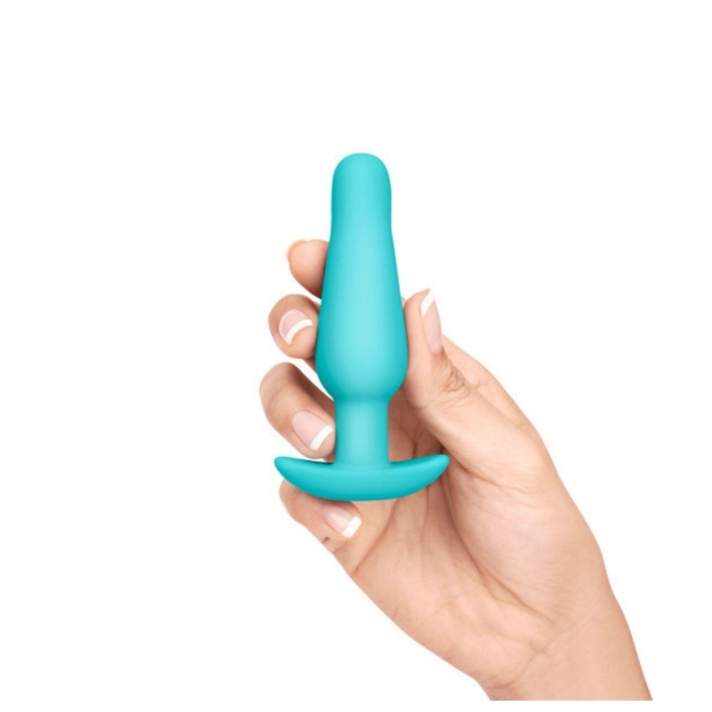 The small butt plug included in the B-Vibe Anal Training Set, being held in a hand