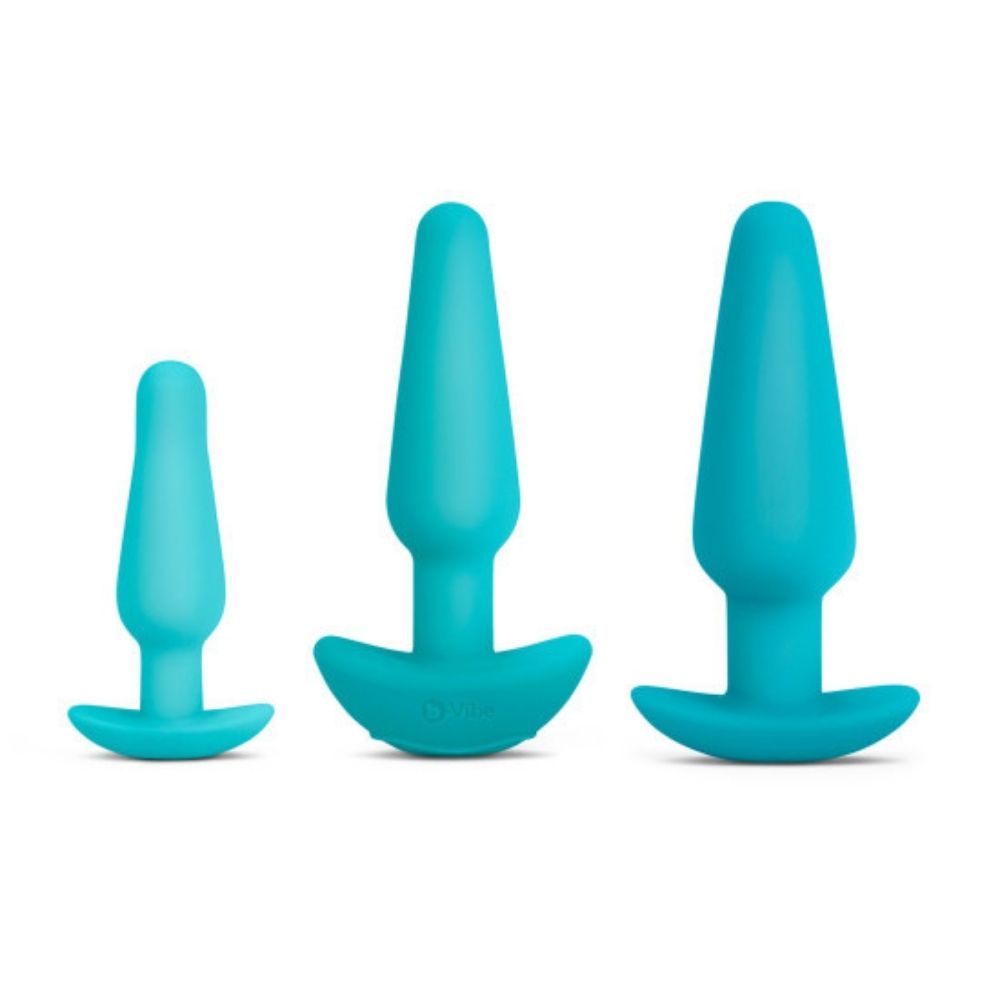 The small, medium and large plugs included in the B-Vibe Anal Training Set, standing upright on their bases