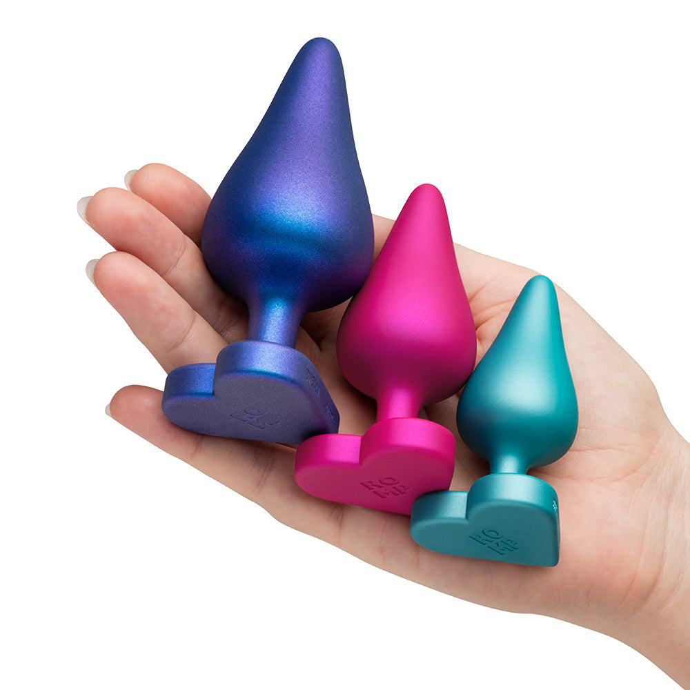 Hand holding ROMP Luster Anal Plug Set