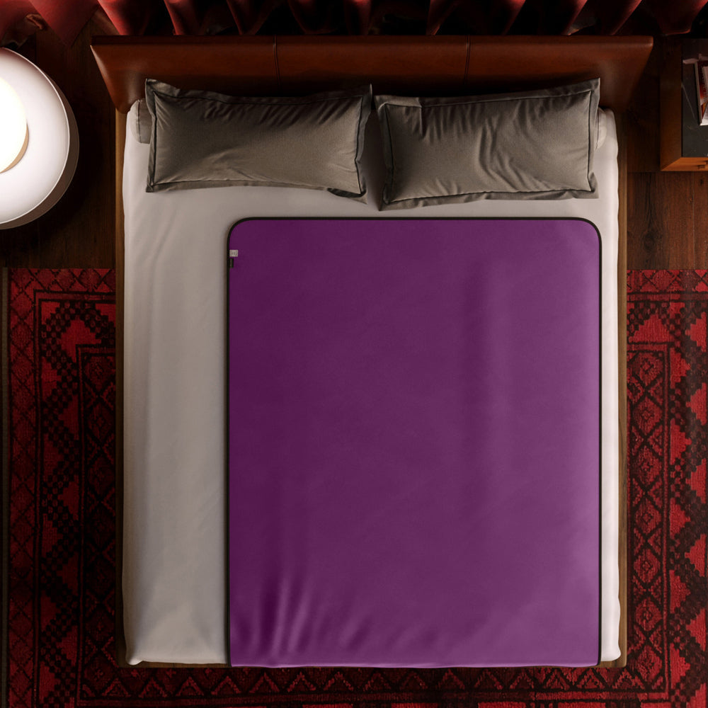 Liberator_Fascinator_Throw_Regular_Purple_on_the_bed