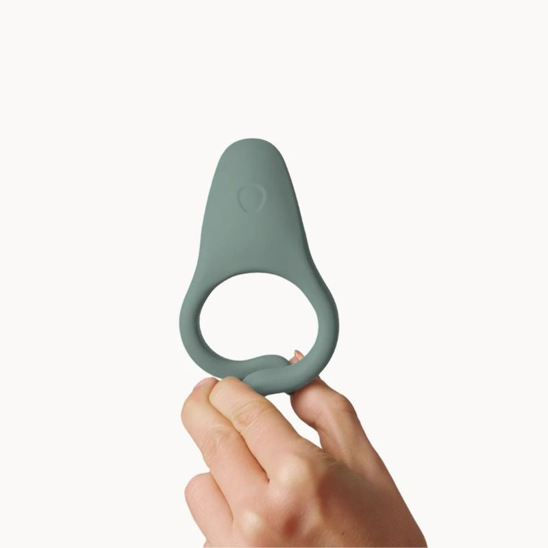 hand holding Dame Hug Vibrating Ring Steel