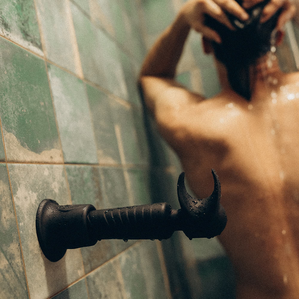 Man Wand Evo 2-in-1 black plum on a shower wall