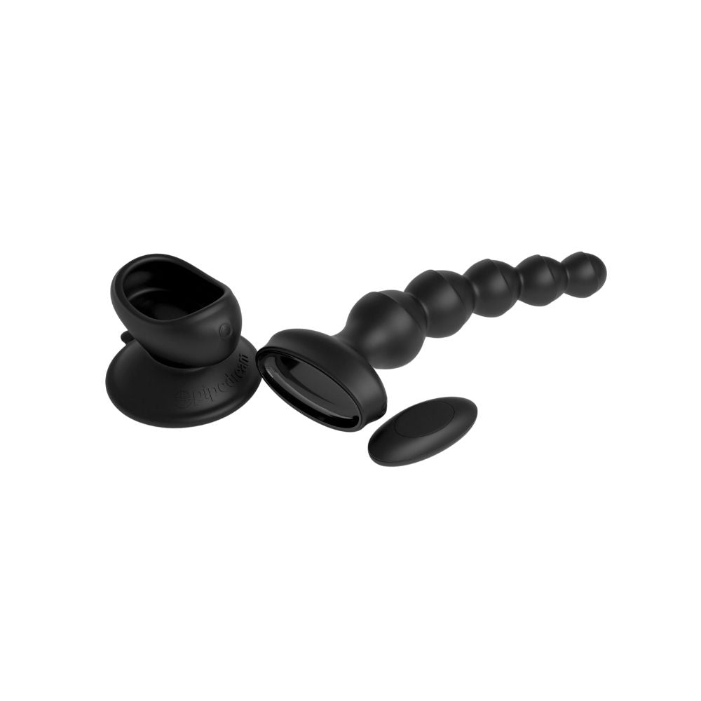 3Some Wall Banger Beads laying flat beside the suction cup base and remote it comes with