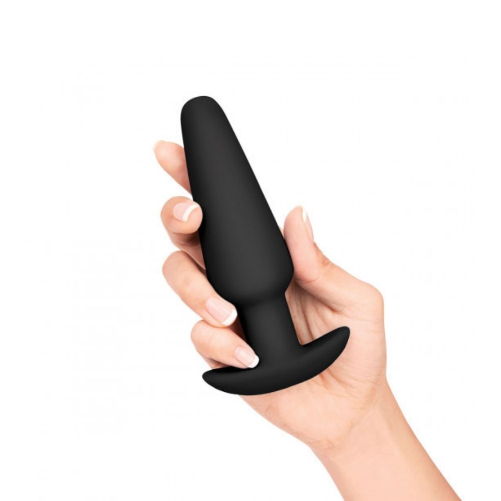 The large weighted butt plug included in the B-Vibe Anal Training Set, being held in a hand
