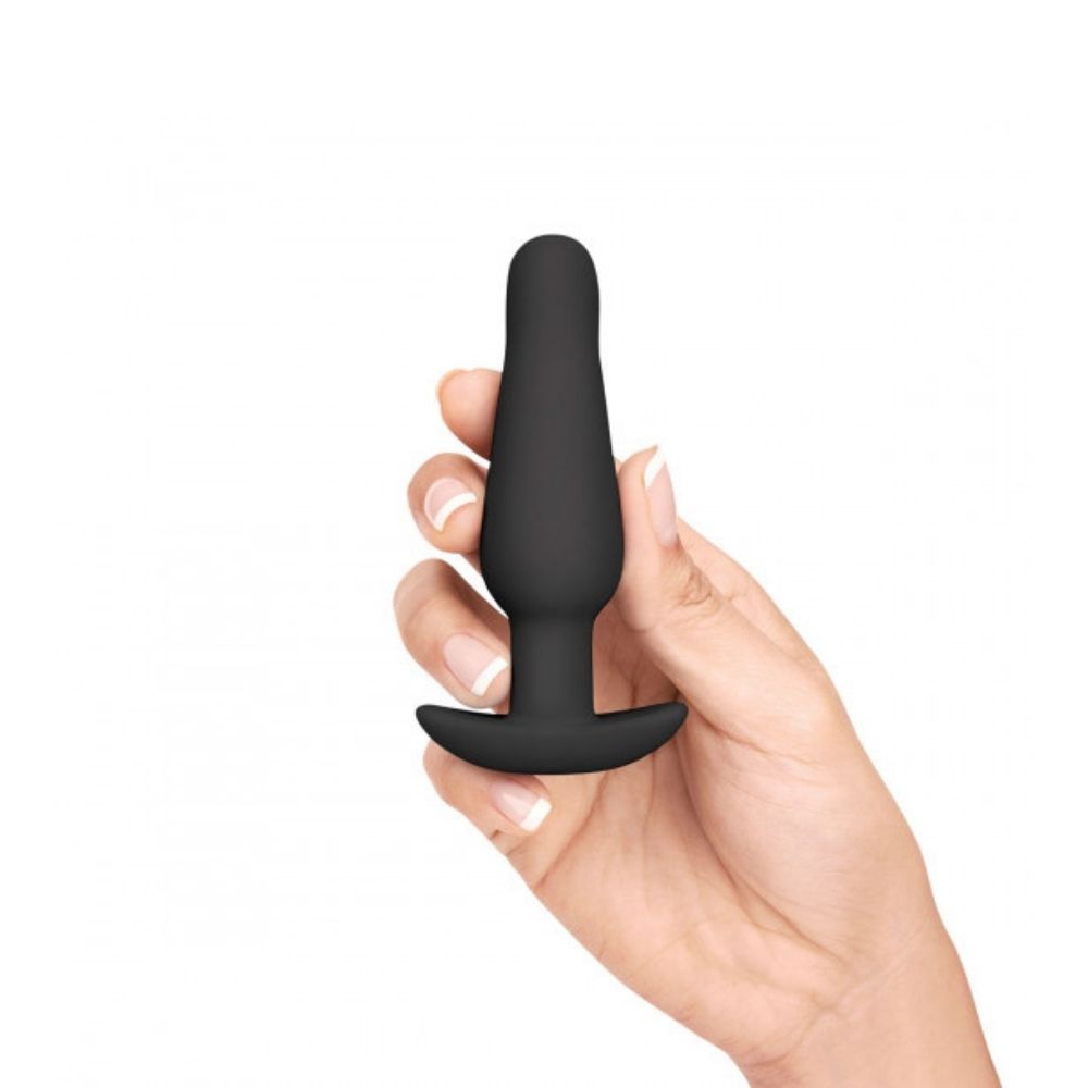 The small butt plug included in the B-Vibe Anal Training Set, being held in a hand