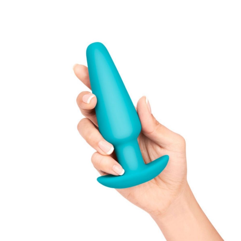 The large weighted butt plug included in the B-Vibe Anal Training Set, being held in a hand