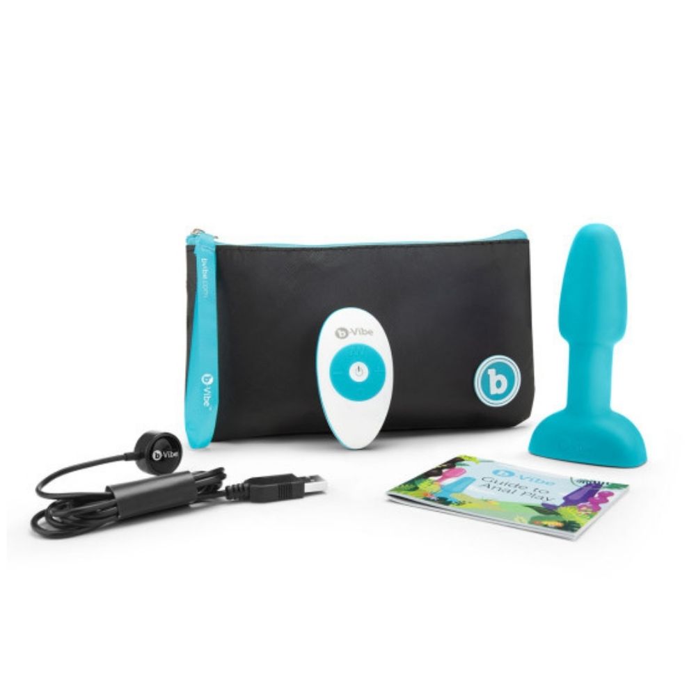 Teal B-Vibe Rimming Petite Plug and the contents of the box, including the remote, charging cable, travel bag and user guide