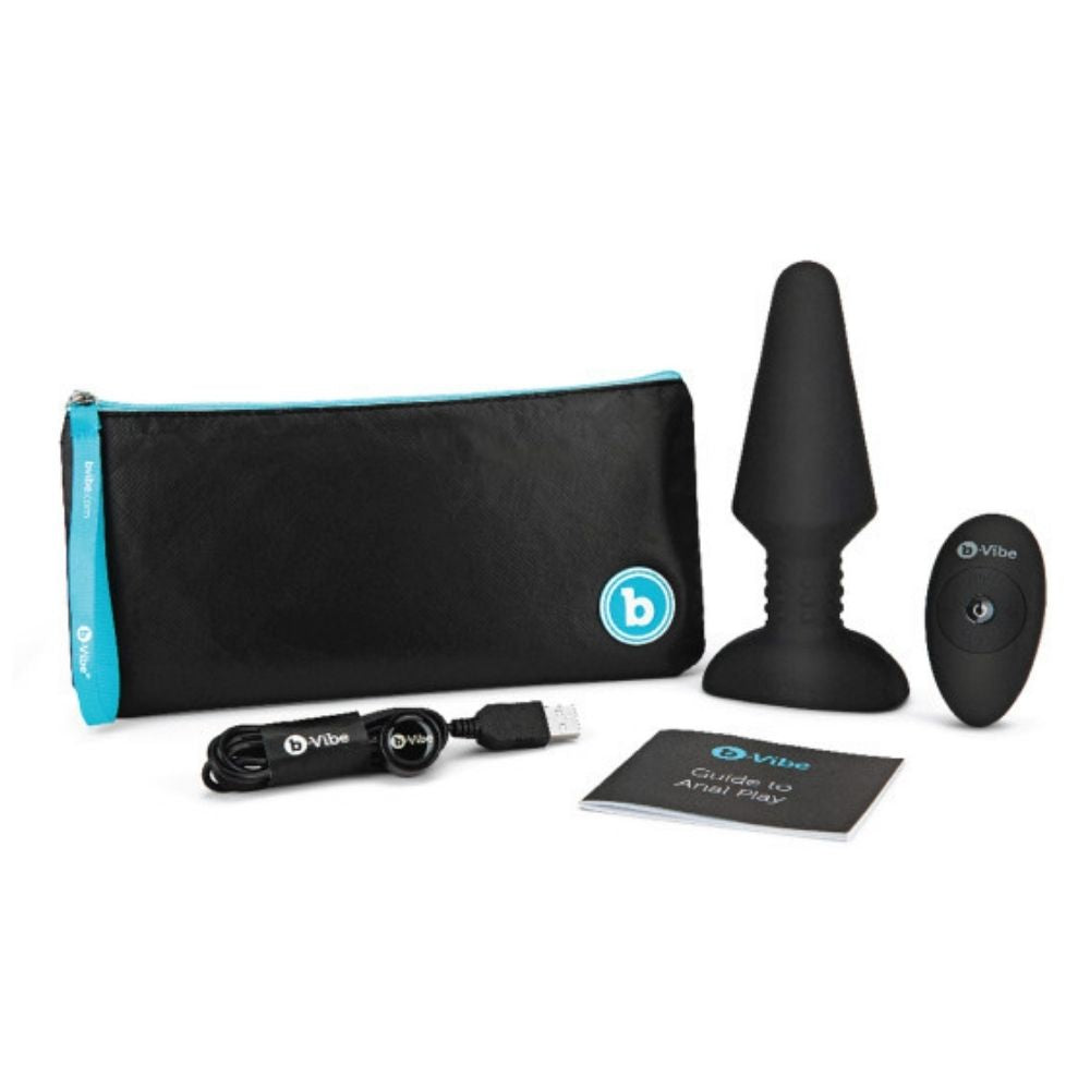 The contents of the B-Vibe Rimming Plug XL box, including the plug, remote, charging cable, travel bag and user guide