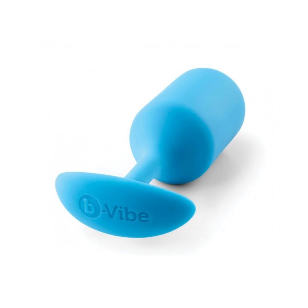 Teal B-Vibe Snug Plug 3 (L) laying flat on its side with the base in the forefront