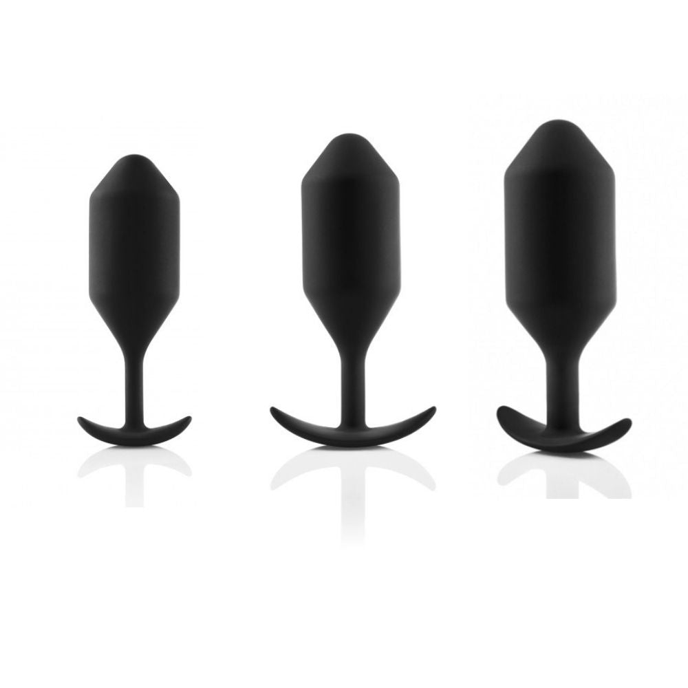 The B-Vibe Snug Plugs in XL, XXL and XXXL standing upright on their bases