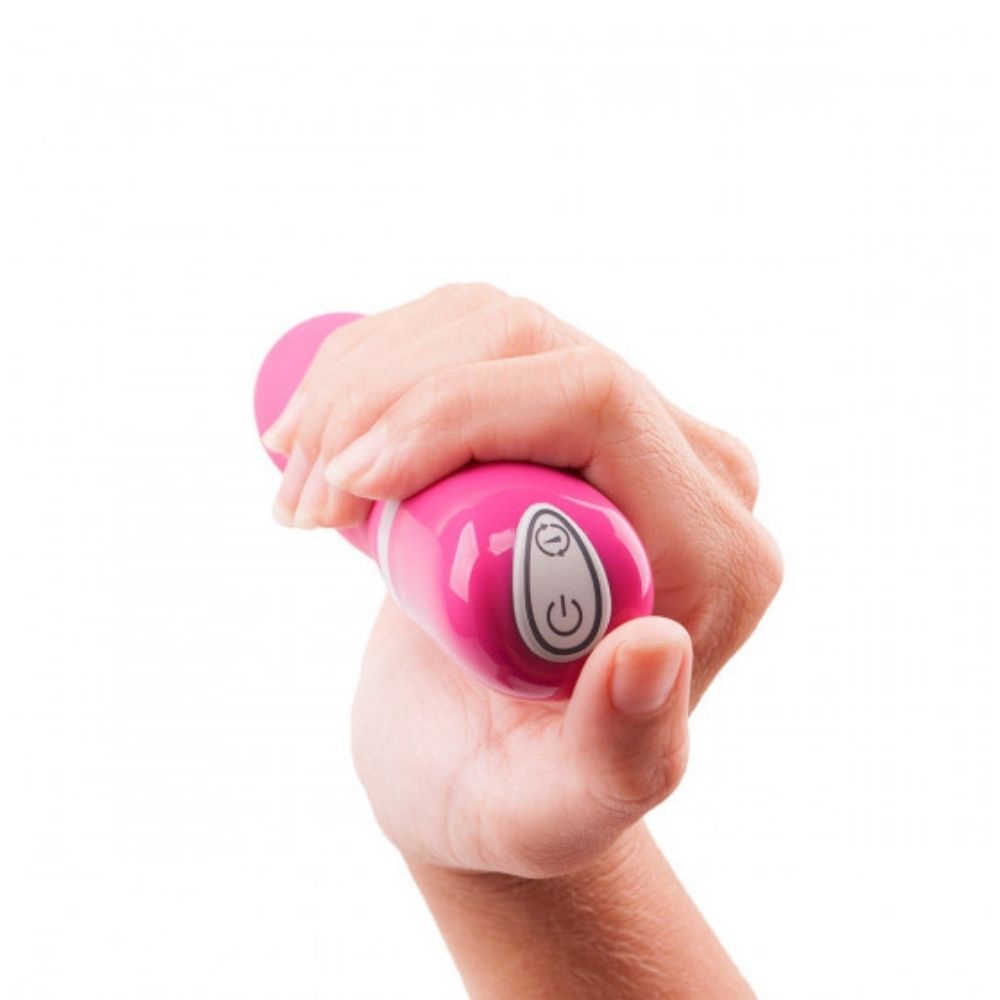 B Swish Bdesired Deluxe Curve in rose, being held with the base of the toy in the forefront showing the power button