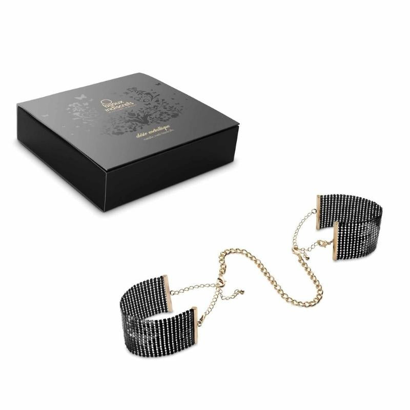 Black Bijoux Indiscrets Desir Metallique Mesh Handcuffs beside the box they come in