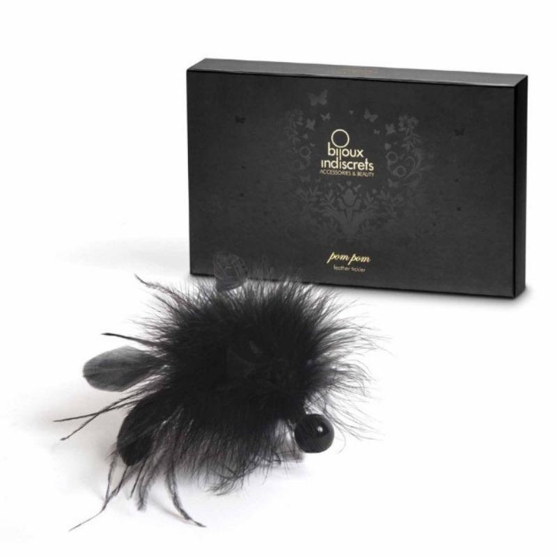 Bijoux Indiscrets Pom Pom Feather Tickler in front of the box it comes in 
