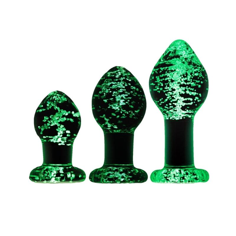 Small, medium and large glow in the dark Firefly Glass Plug standing on their bases