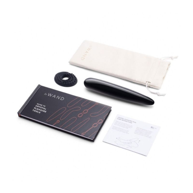 Le Wand Crystal Slim in Black Obsidian with everything it comes with, including the attachment, pouch and user guide.