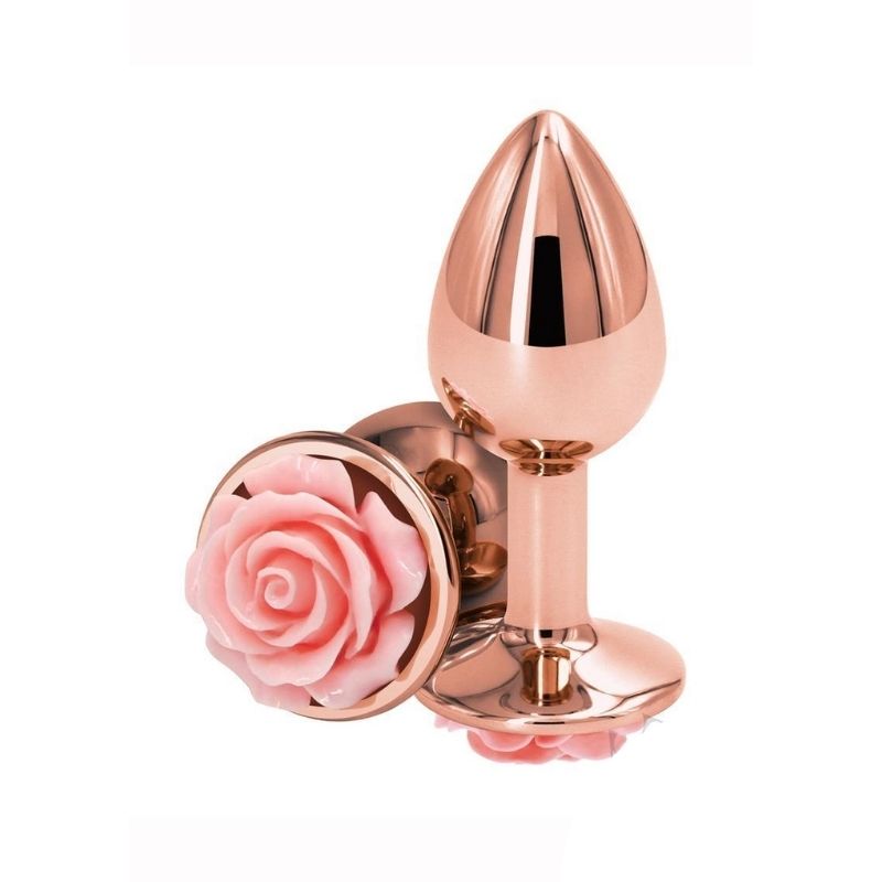 Two Medium Rear Assets Rose Anal Plugs with a pink rose base and rose gold colored body. One positioned on side showing the pink rose base, the other standing upright on base