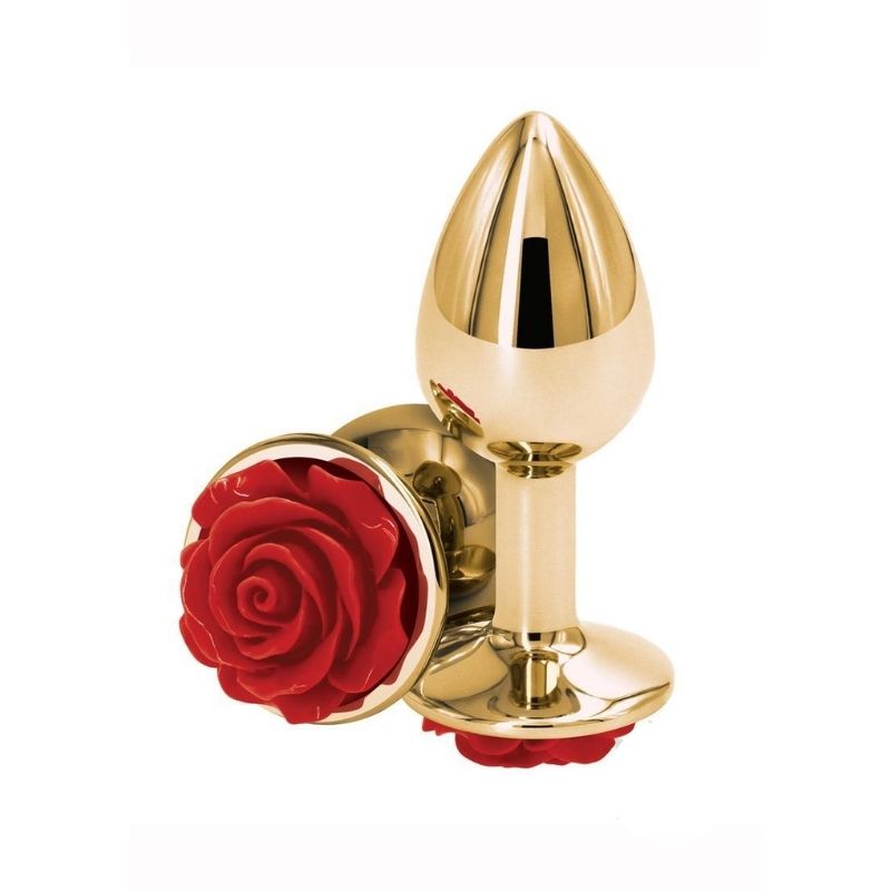 Two Medium Rear Assets Rose Anal Plugs with a red rose base and gold colored body. One positioned on side showing the red rose base, the other standing upright on base