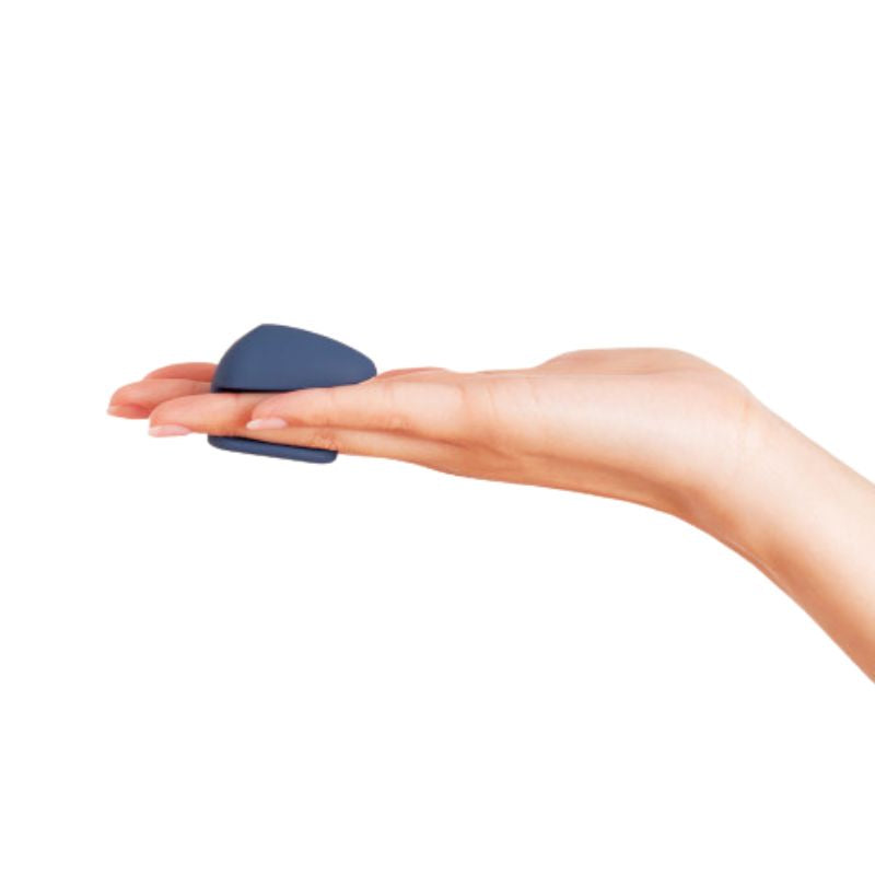 The Wearable by Deia remote held in hand between fingers