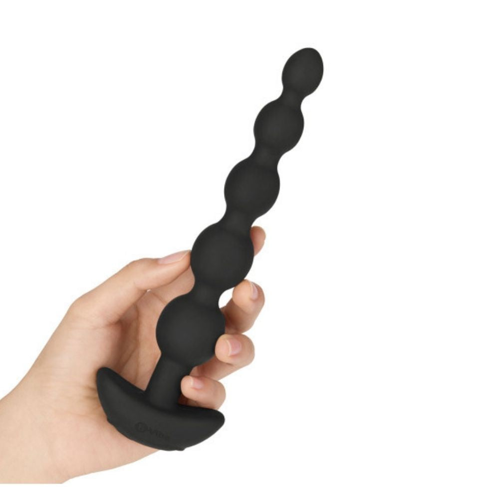B-Vibe Cinco Beads held in hand, pointing upward