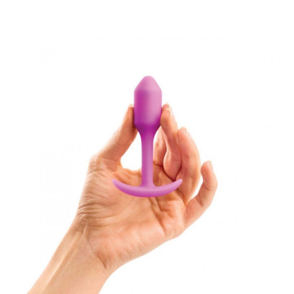 Fuchsia B-Vibe Snug Plug 1 (S) held in hand