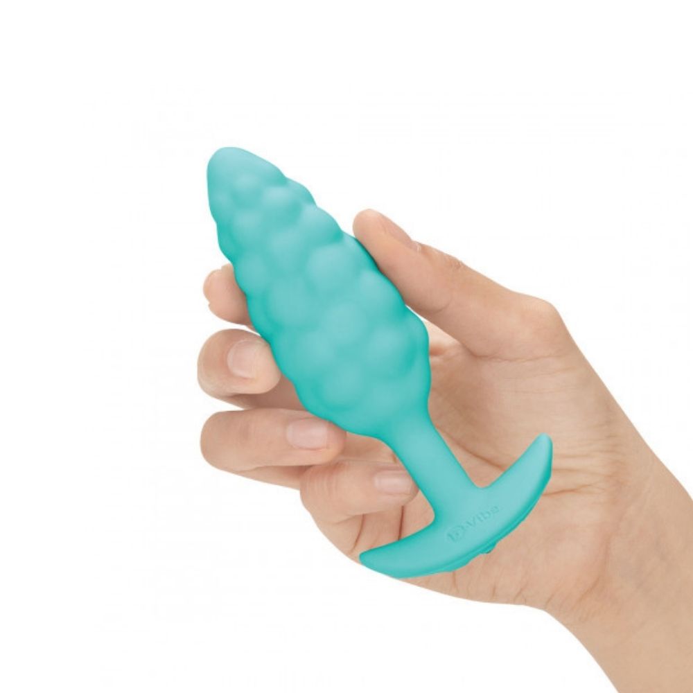 B-Vibe Texture Plug Bump Aqua (Small) being held in hand