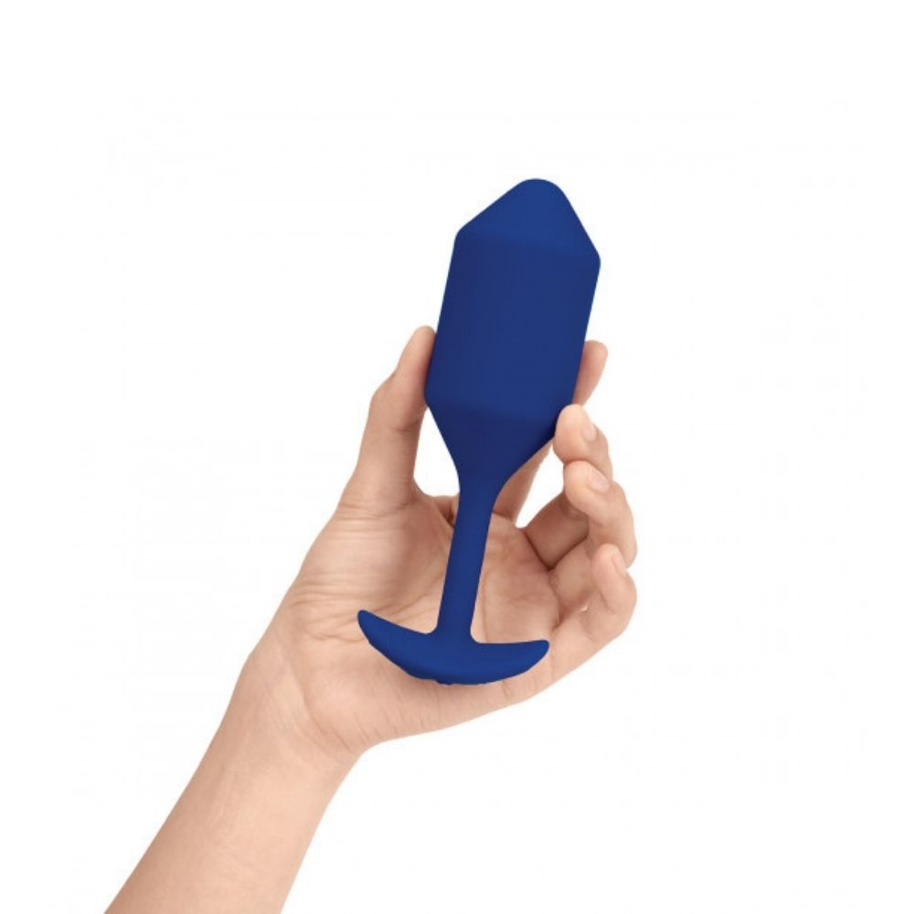 Navy B-Vibe Vibrating Snug Plug 4 (XL) being held in hand