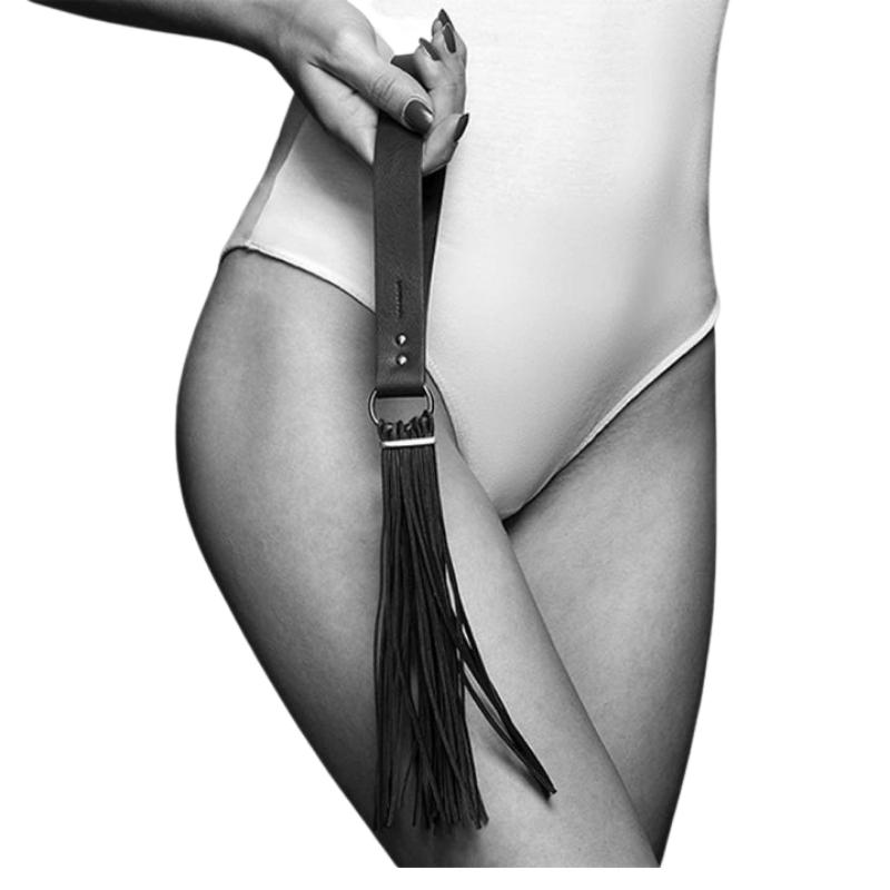 Bijoux Indiscrets Maze Tassel Flogger held in hand by the hand loop