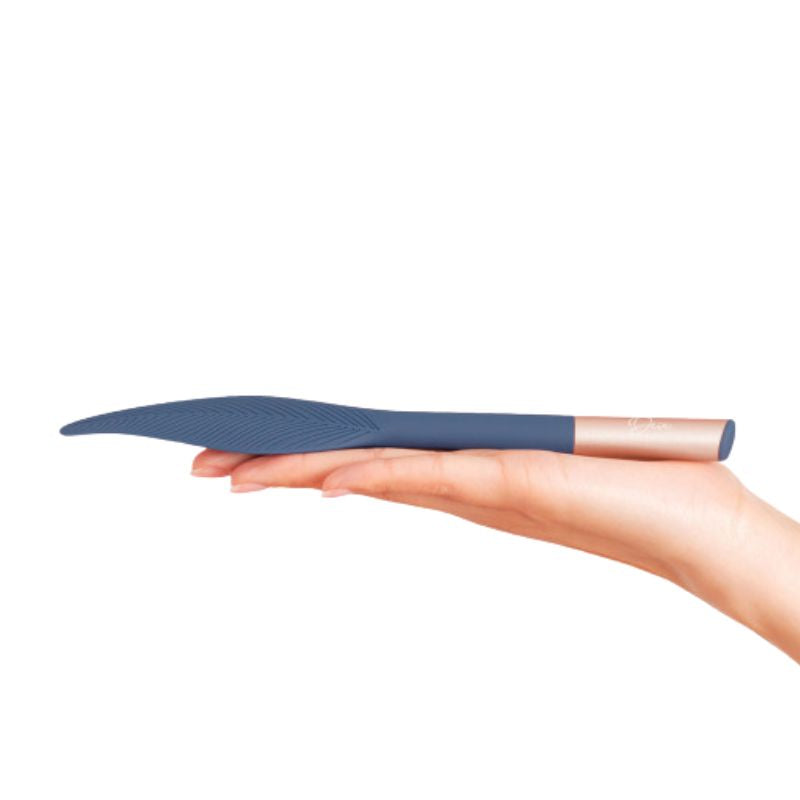 The Feather by Deia laying flat on the palm of a hand